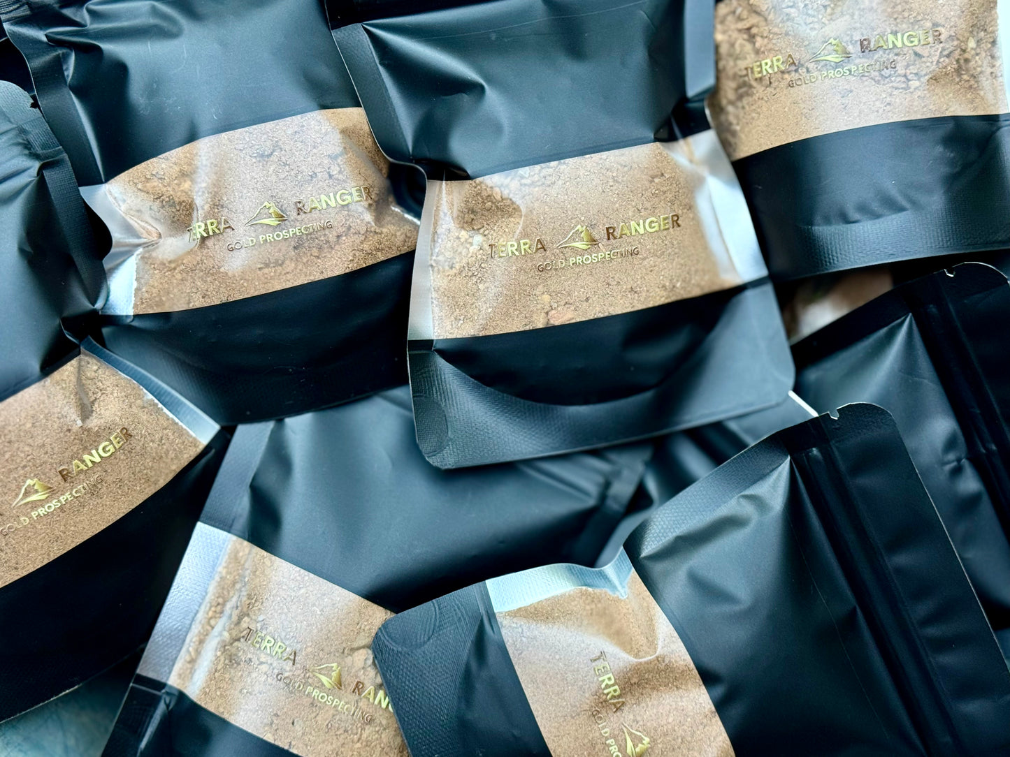 Packages of TERRA RANGER PAYDIRT with visible branding on a black background