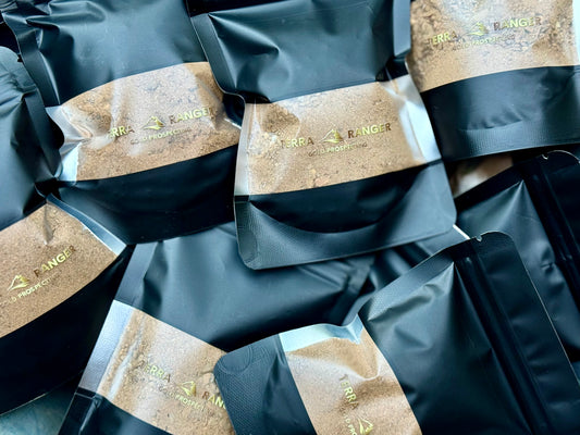 Packages of TERRA RANGER PAYDIRT with visible branding on a black background